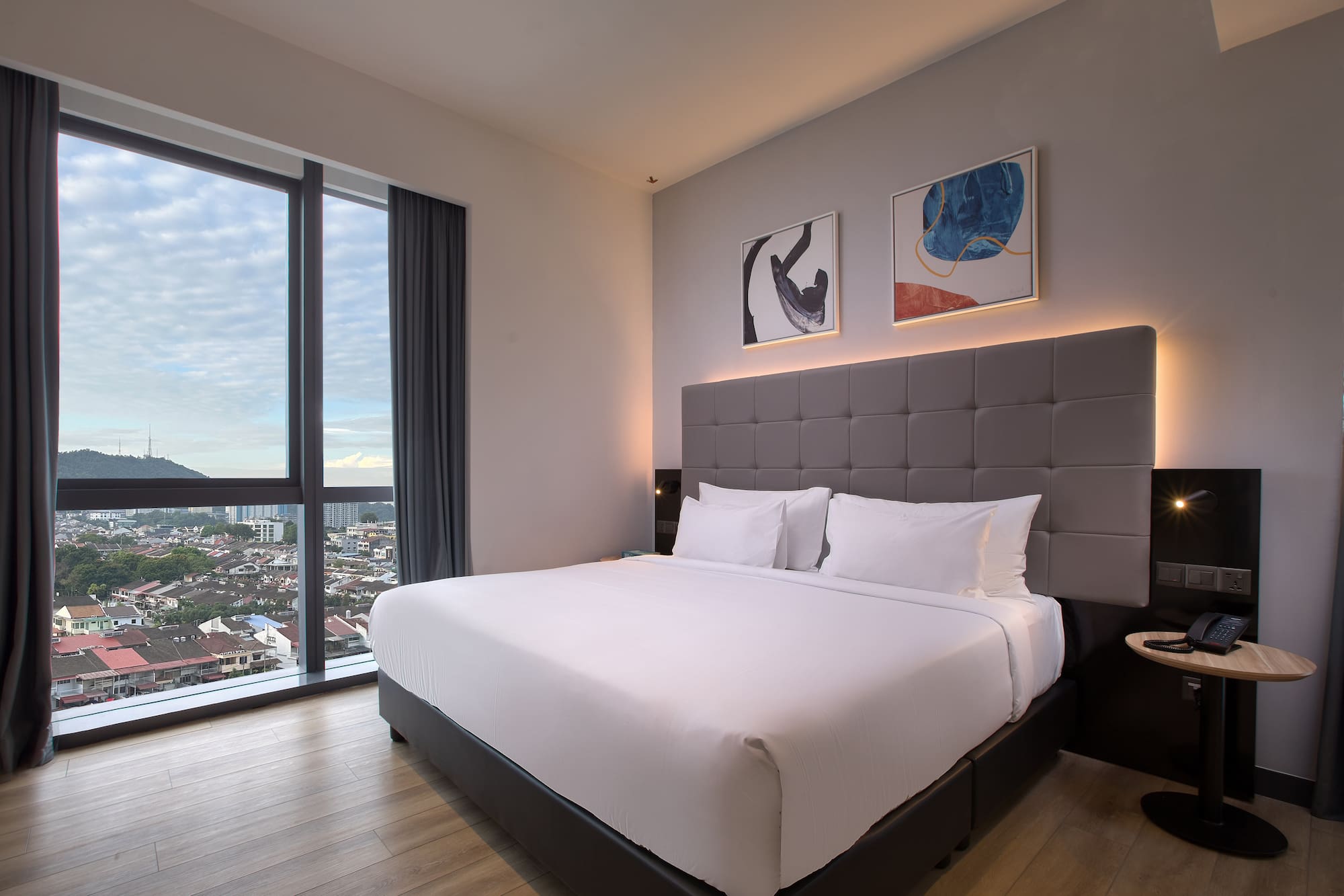 a bed in a room with a view of a city
