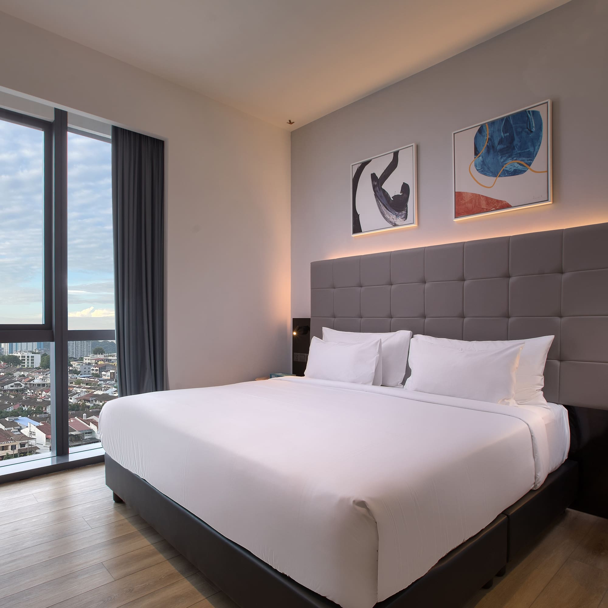a bed in a room with a view of a city
