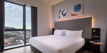 a bed in a room with a view of a city
