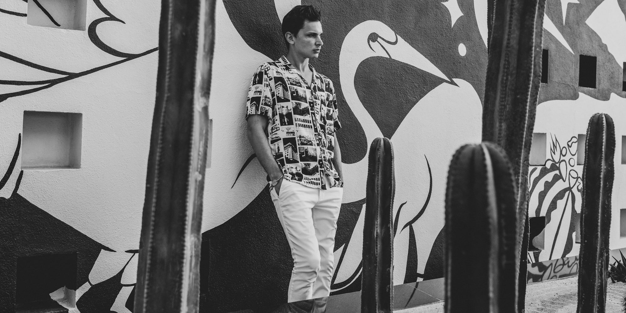 a man leaning against a wall