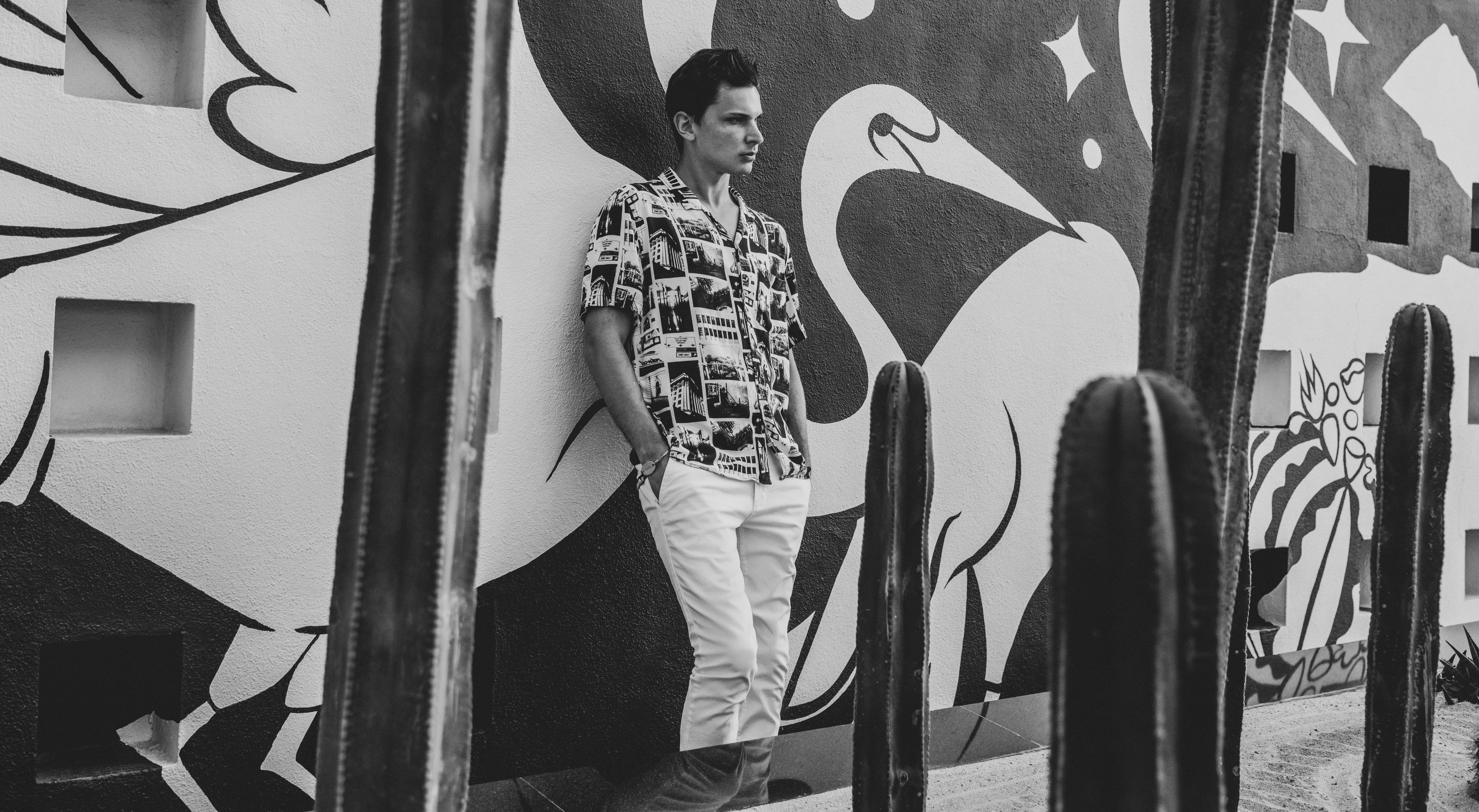 a man leaning against a wall