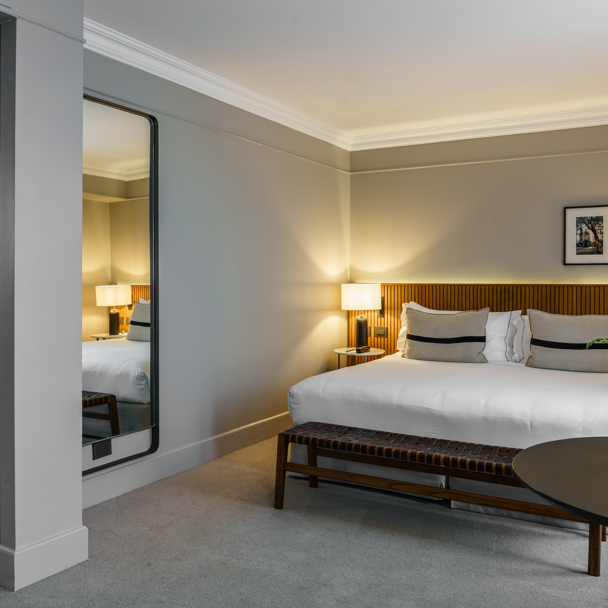 a bedroom with a mirror and a bed