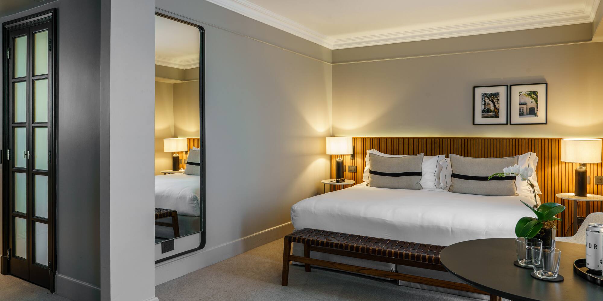 a bedroom with a mirror and a bed