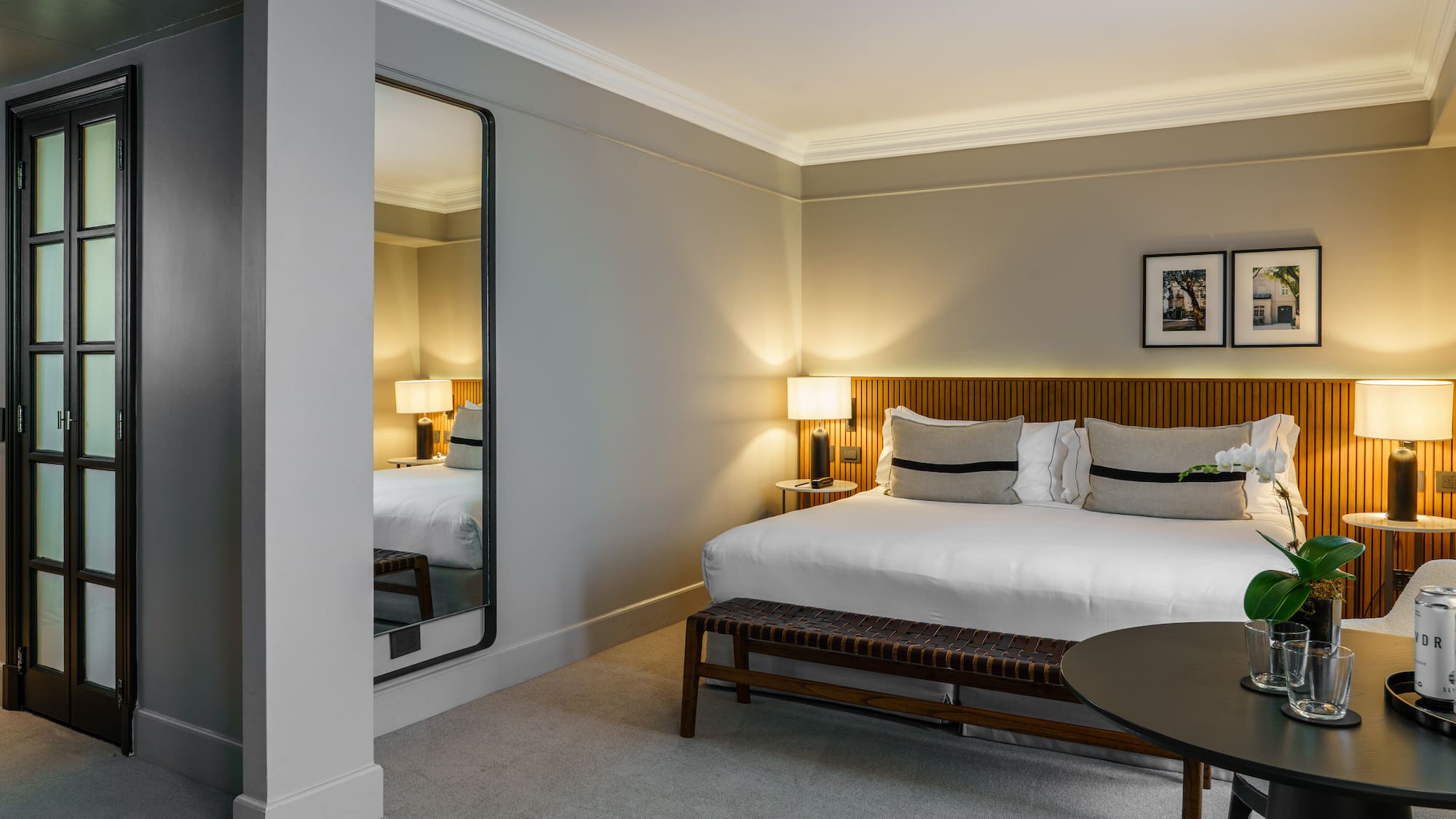 a bedroom with a mirror and a bed