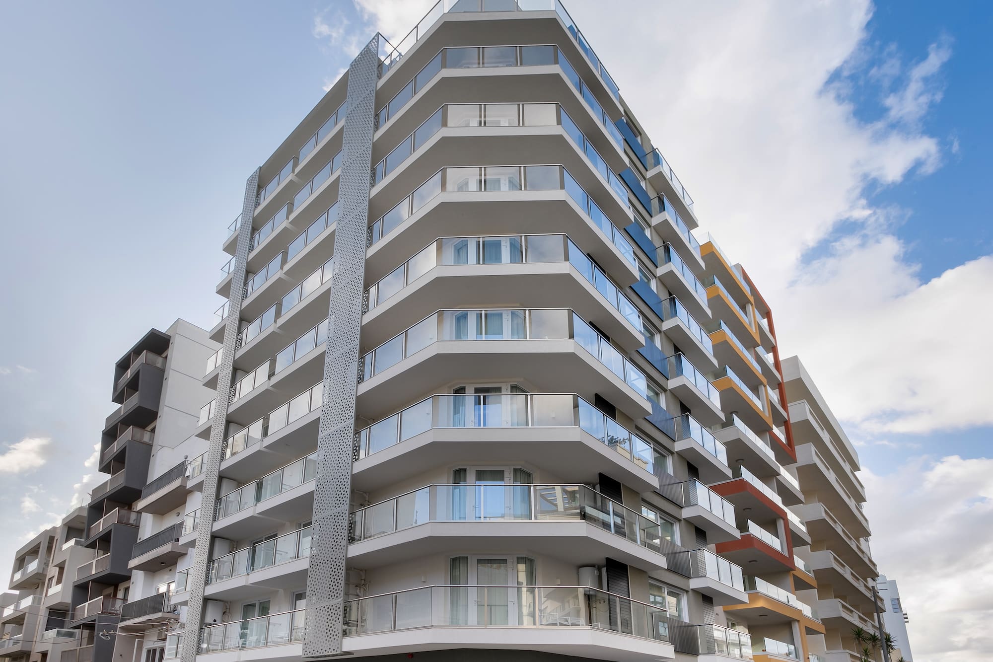 Modern Hotel Mistral building with glass balconies and geometric design.