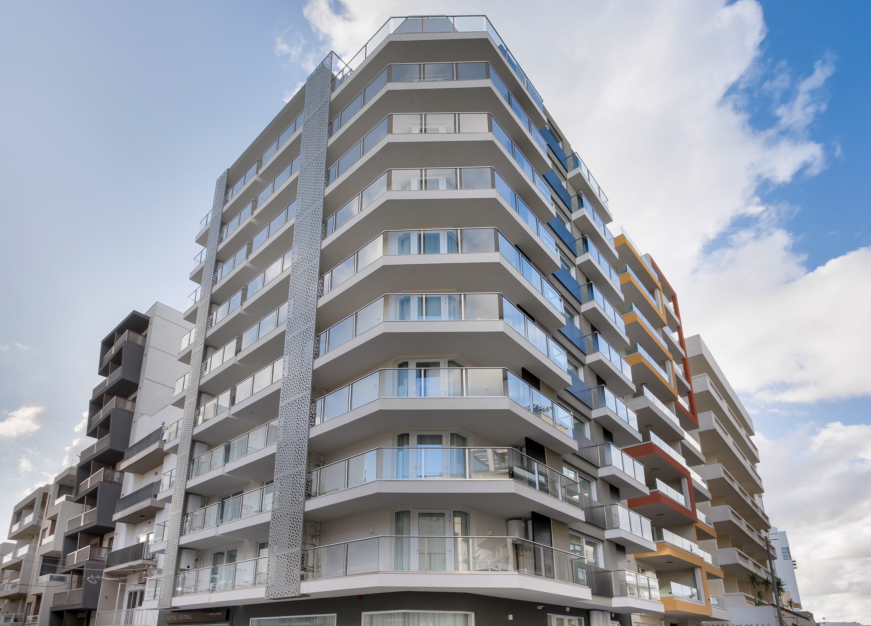 Modern Hotel Mistral building with glass balconies and geometric design.