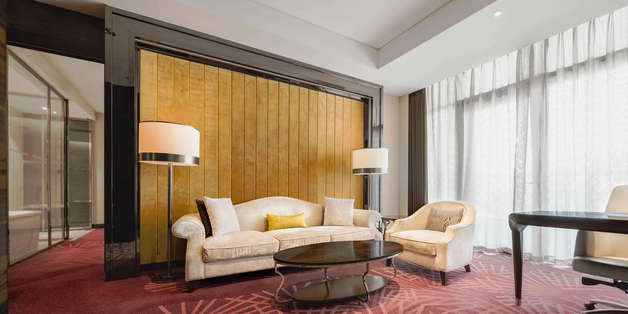 a room with a couch and chairs