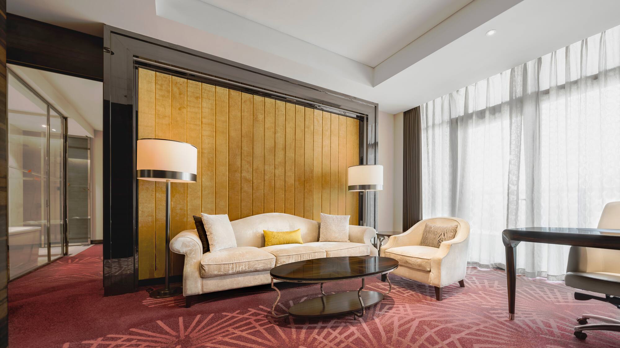 a room with a couch and chairs