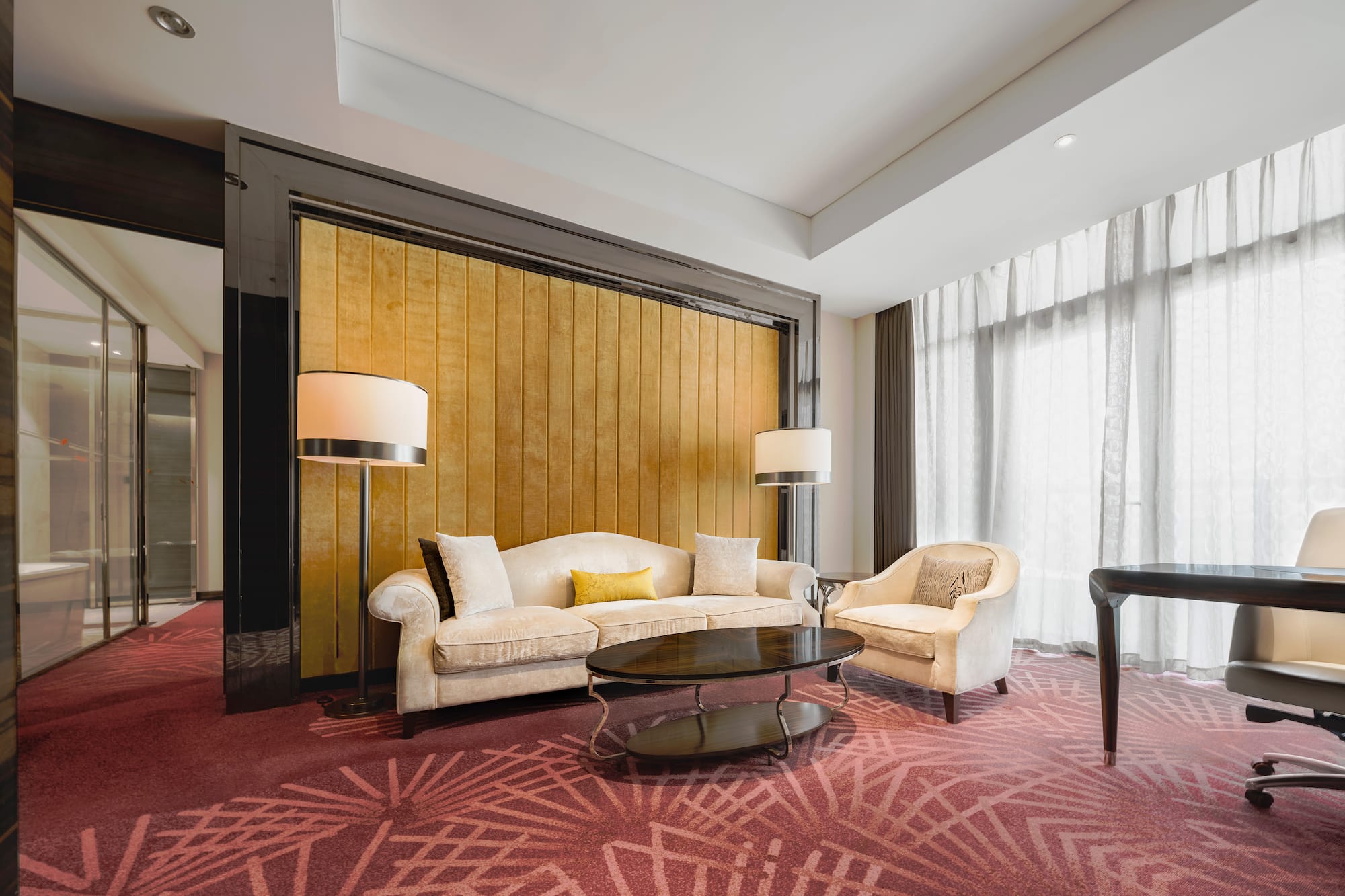 a room with a couch and chairs