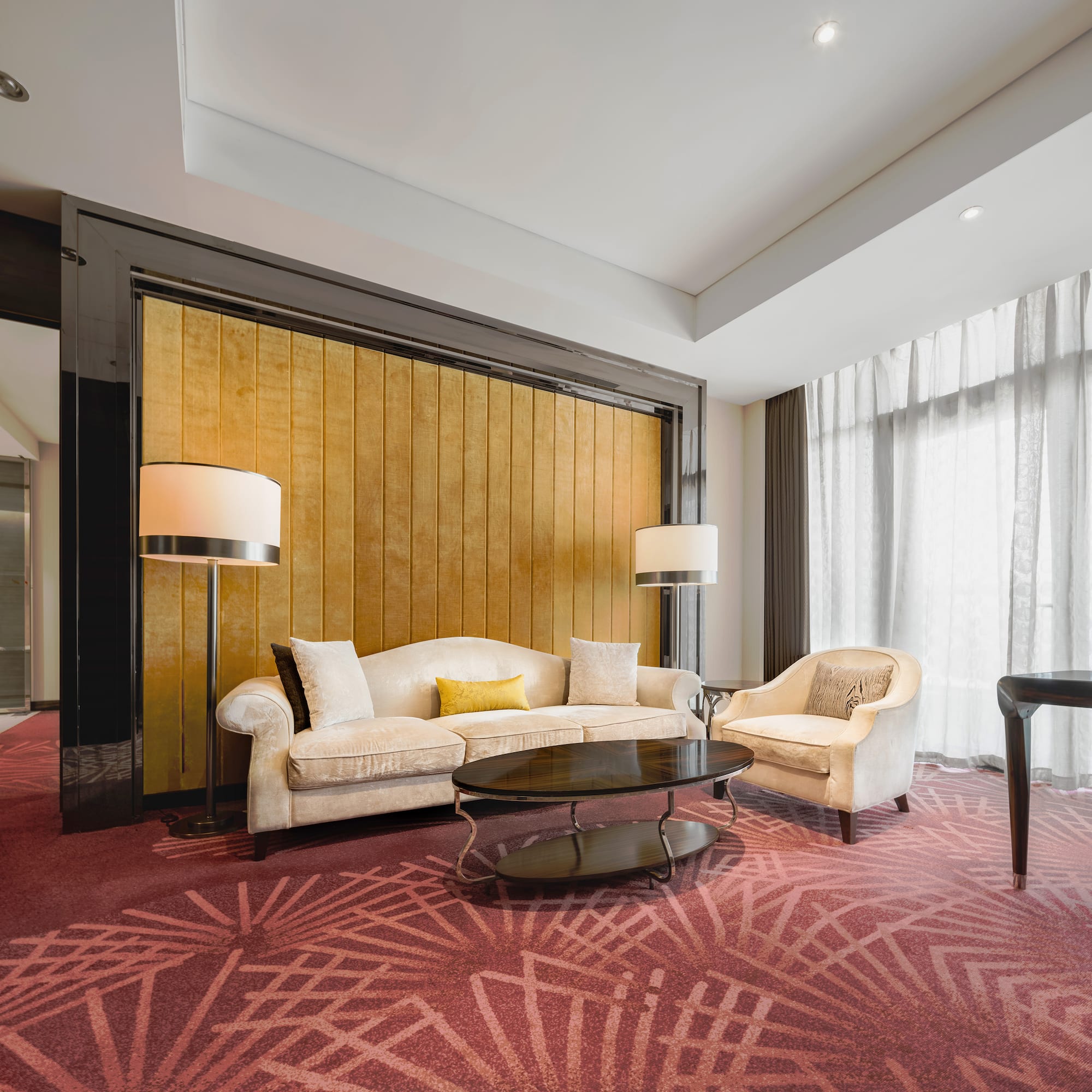 a room with a couch and chairs