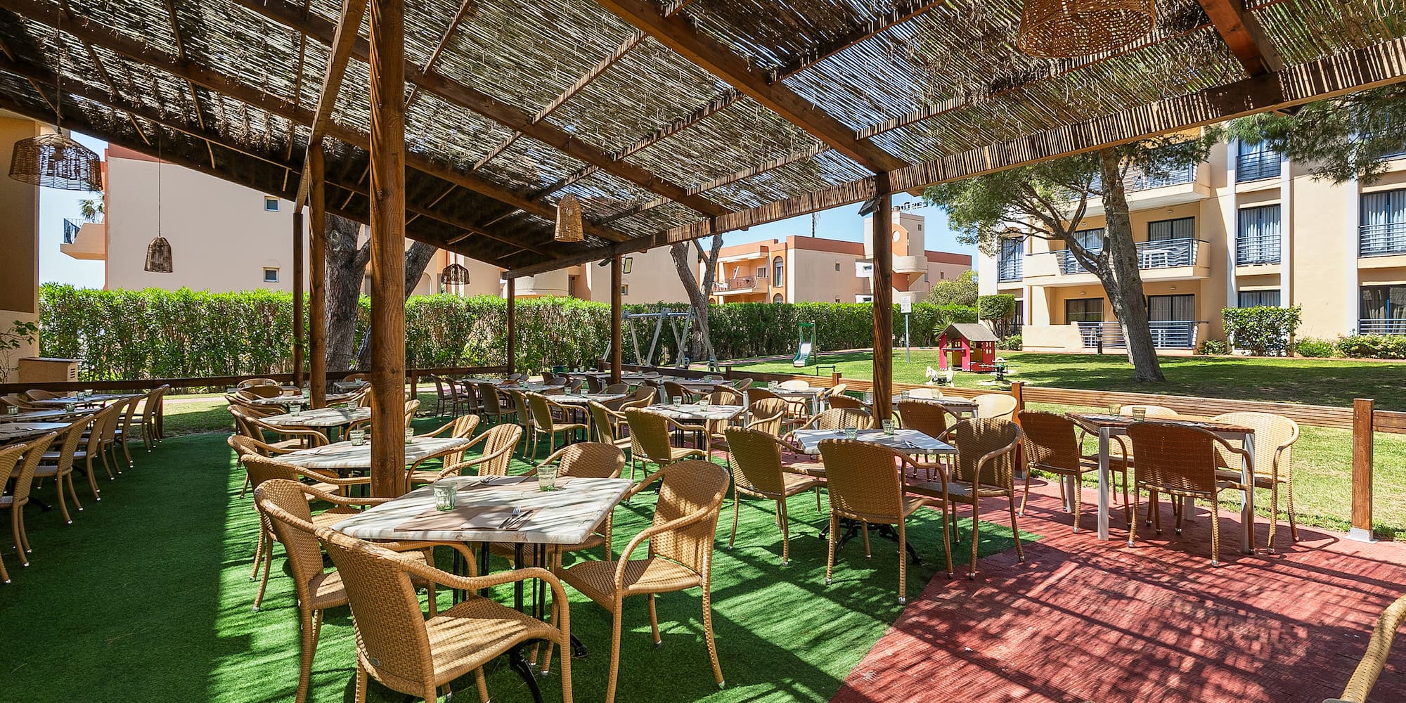 a covered patio area with tables and chairs