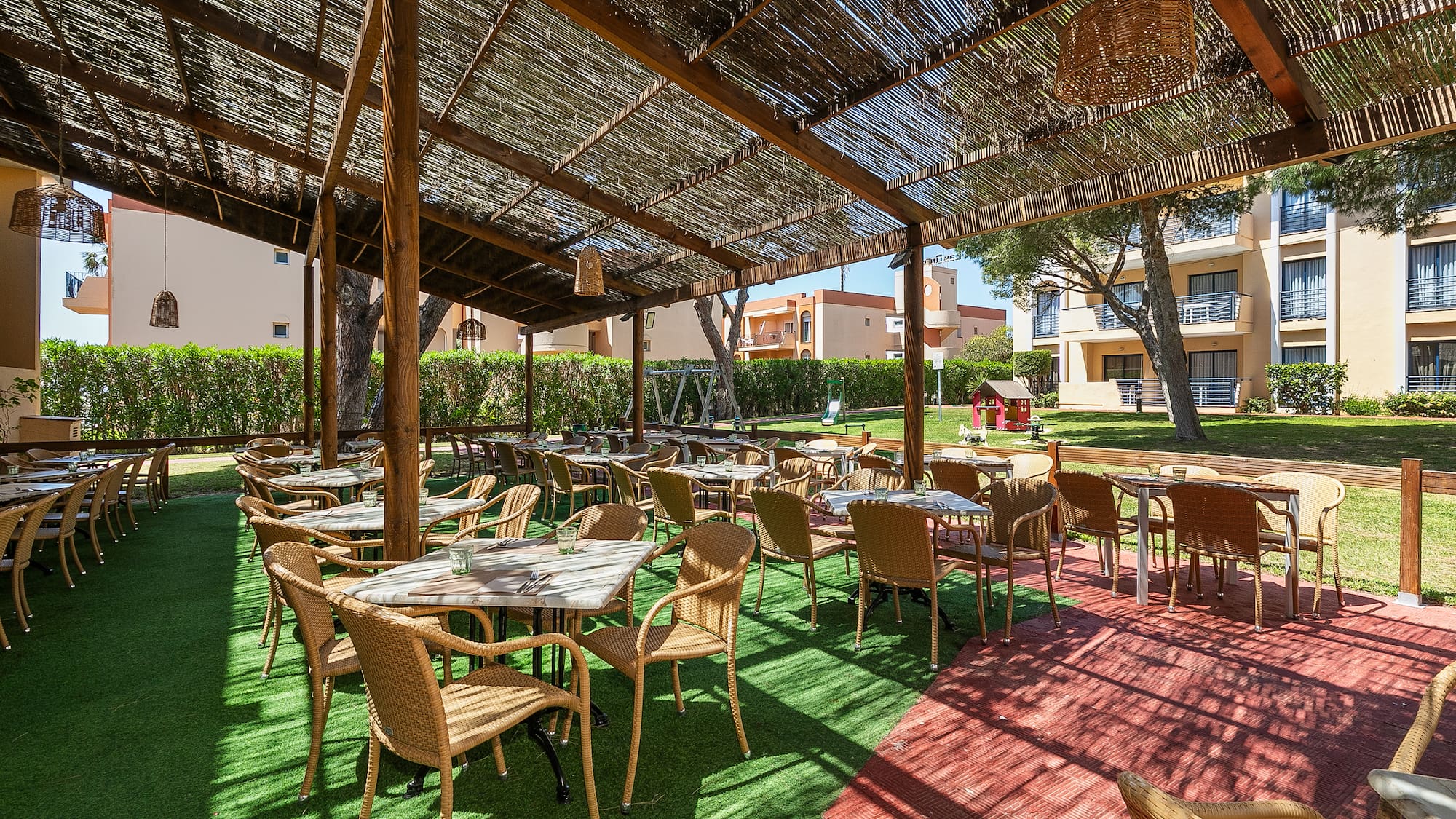 a covered patio area with tables and chairs