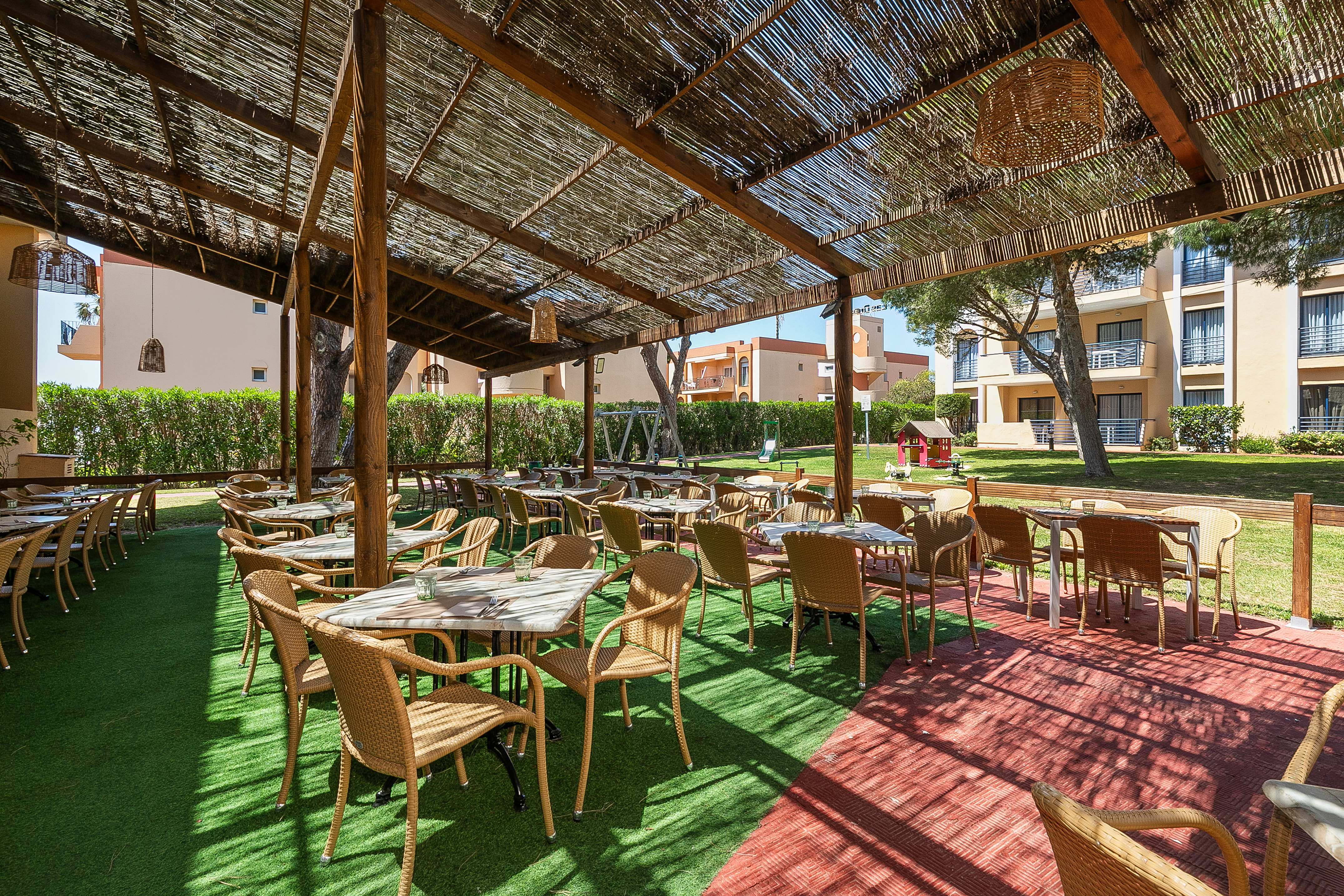 a covered patio area with tables and chairs