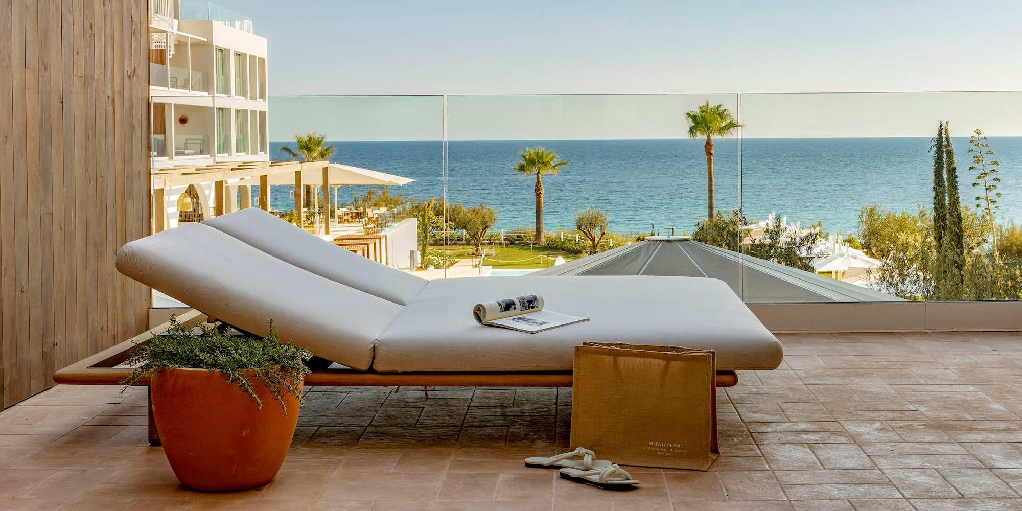 a lounge chair on a patio overlooking a body of water