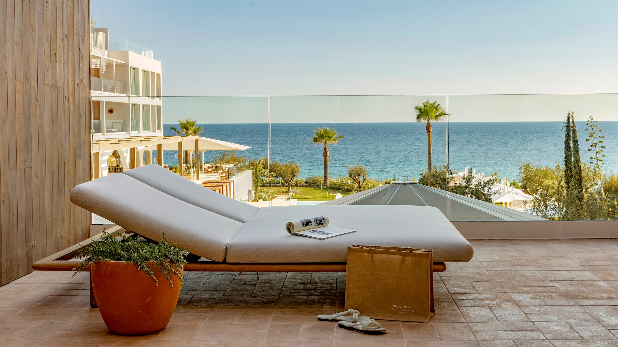 a lounge chair on a patio overlooking a body of water