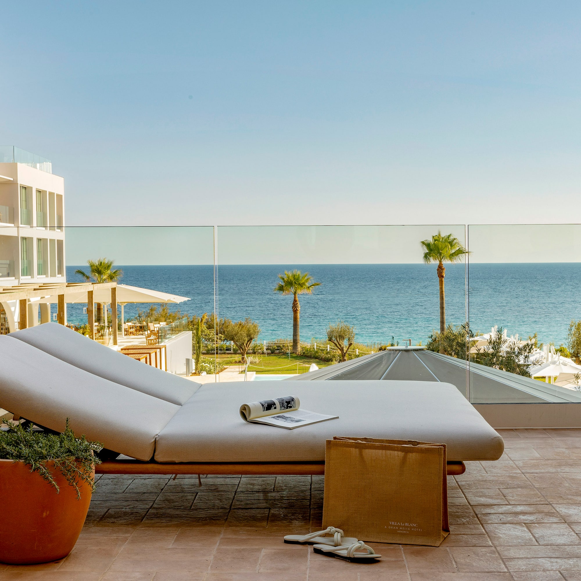 a lounge chair on a patio overlooking a body of water