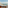 Oceanfront hotel balcony with daybed, sea view, and palm trees.