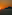 Puesta de sol naranja sobre el mar con silueta de montaña.
