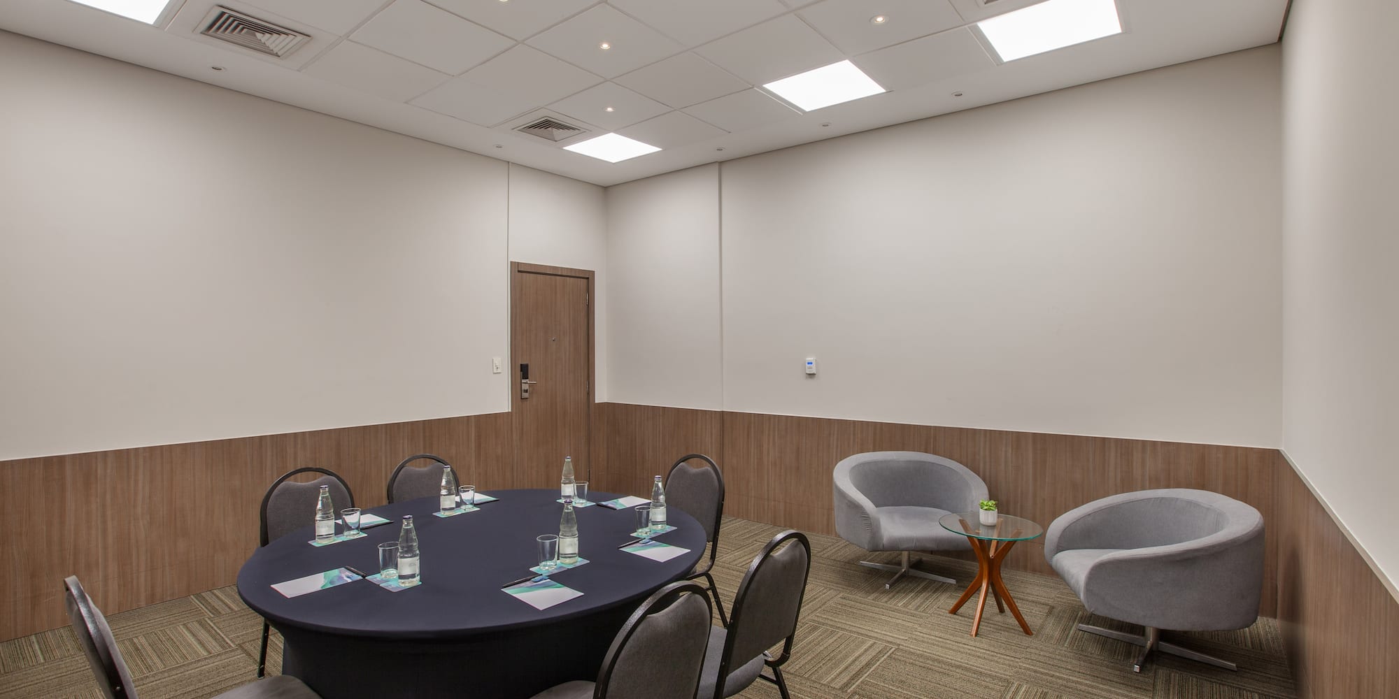 a room with a round table and chairs