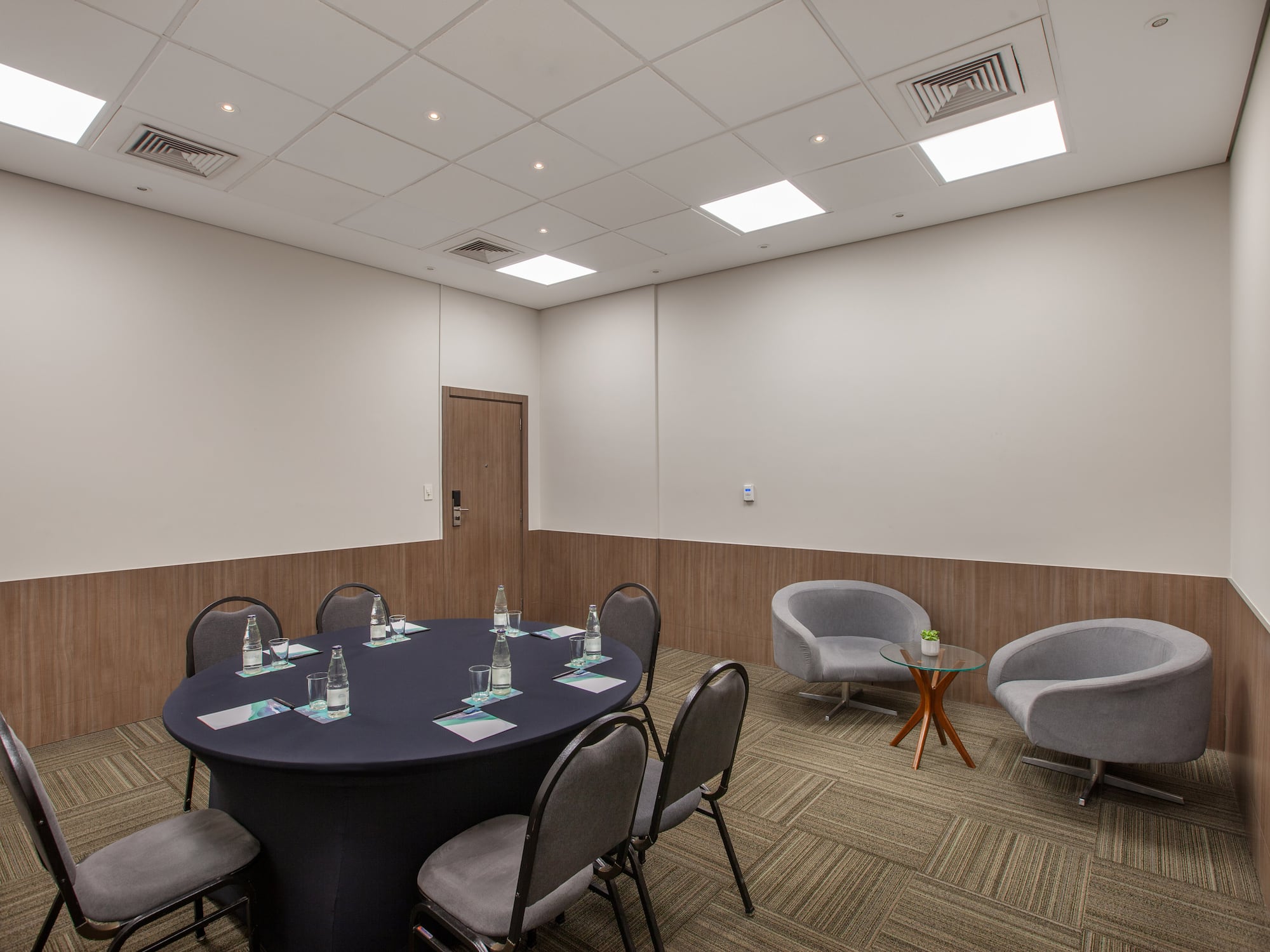 a room with a round table and chairs