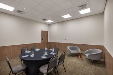 a room with a round table and chairs