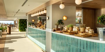 a restaurant with a counter and shelves