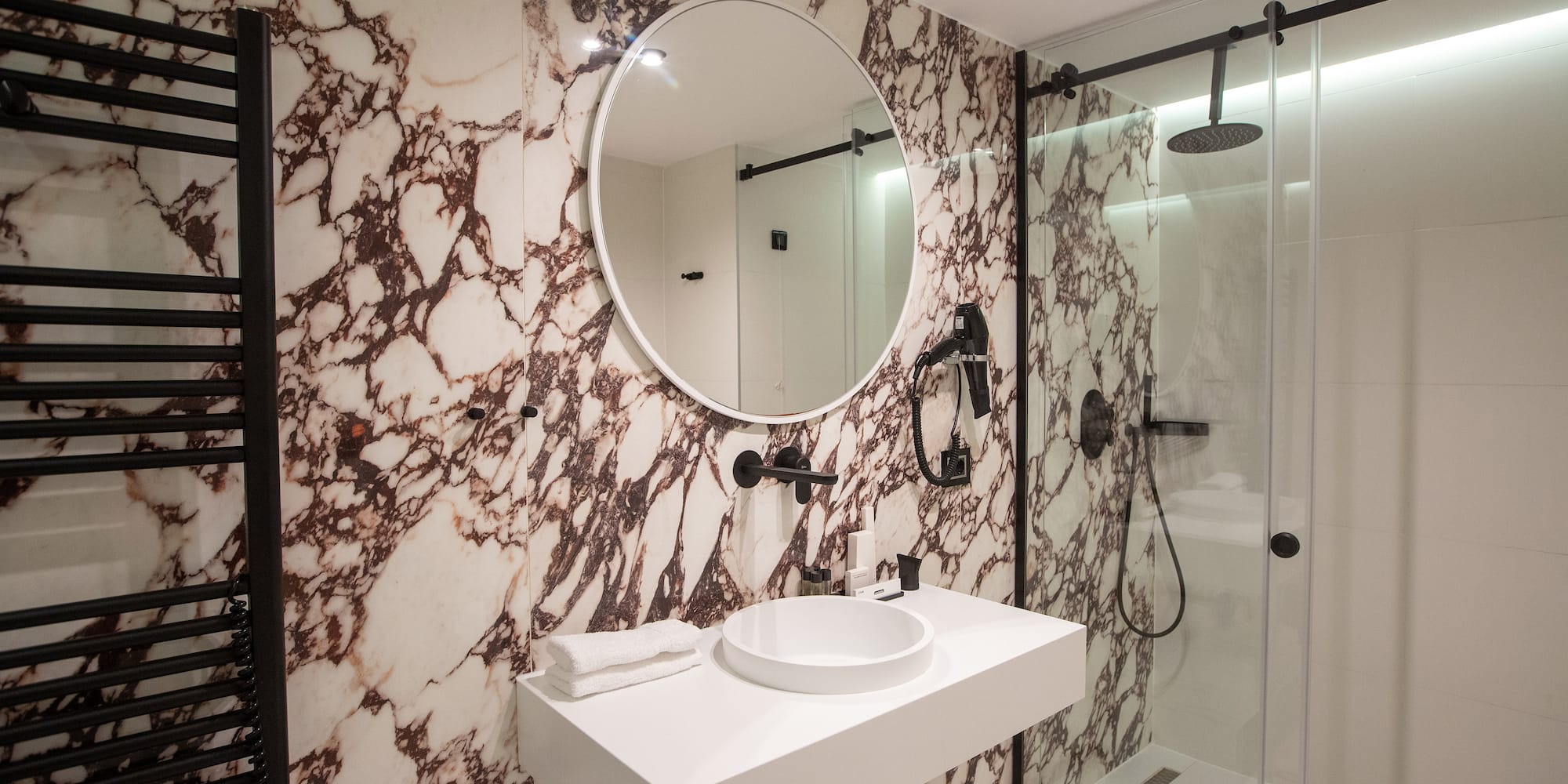 a bathroom with a mirror and a shower