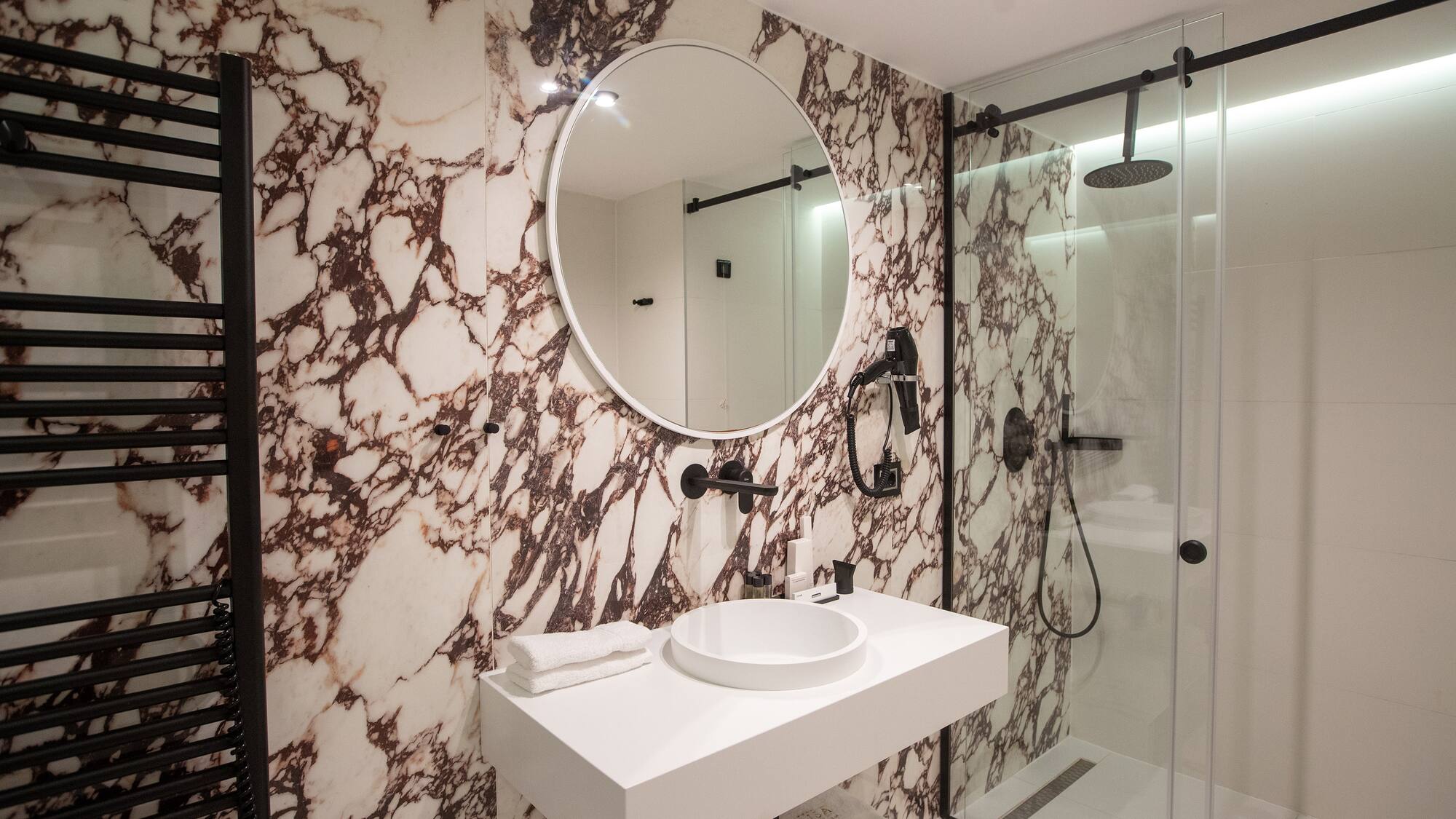a bathroom with a mirror and a shower