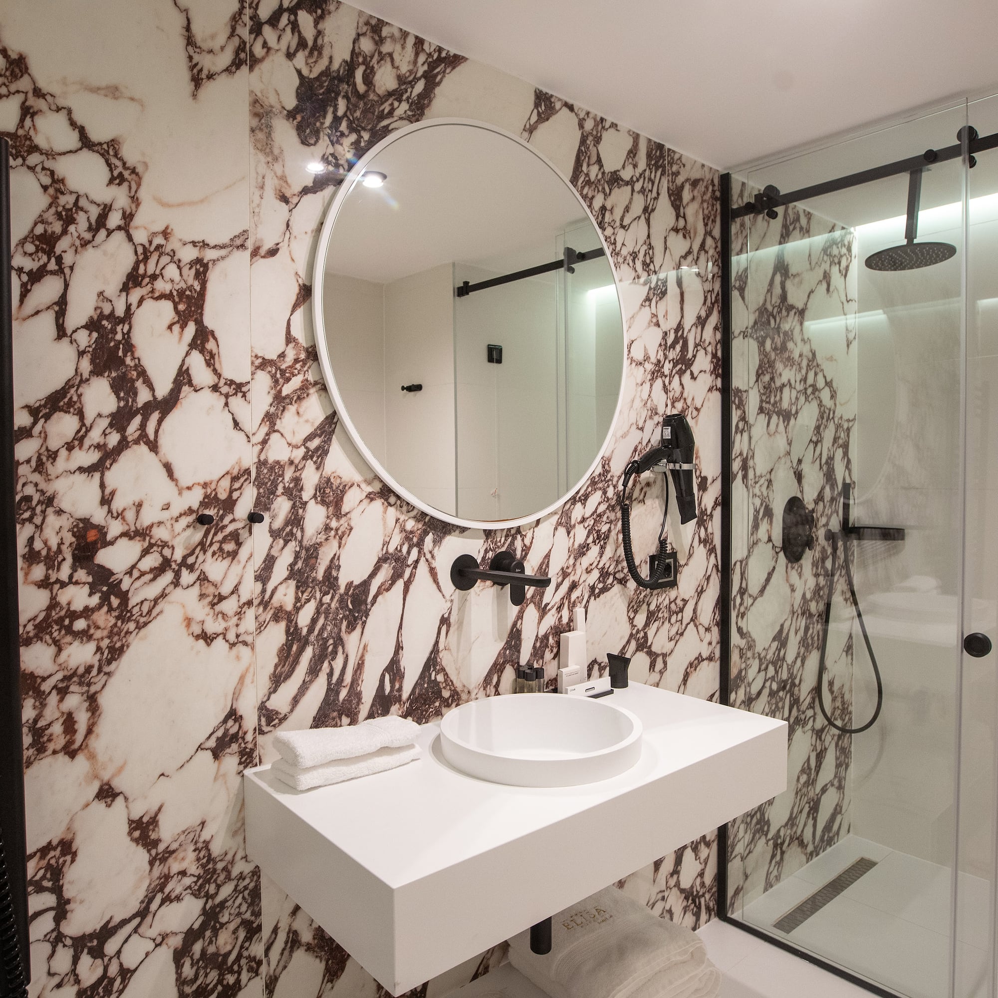 a bathroom with a mirror and a shower