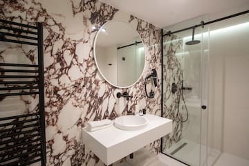 a bathroom with a mirror and a shower