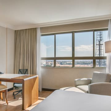 a room with a desk and chair and a large window