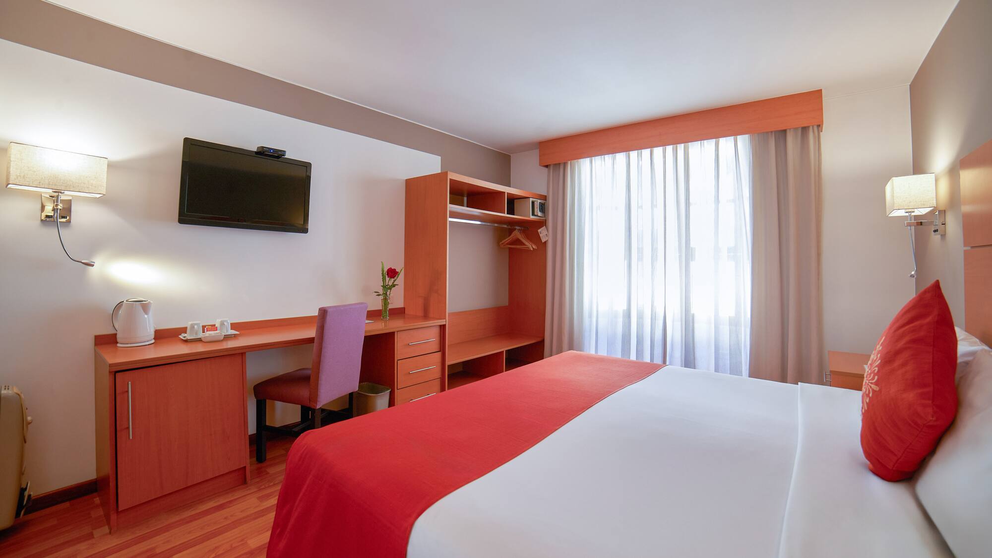 a room with a bed and a desk