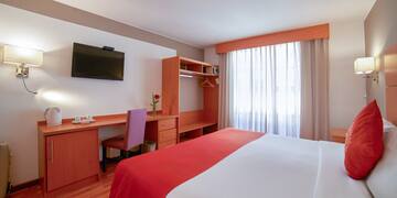 a room with a bed and a desk