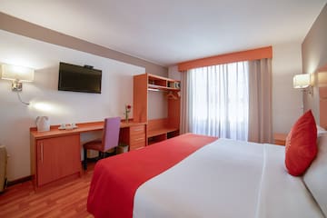 a room with a bed and a desk