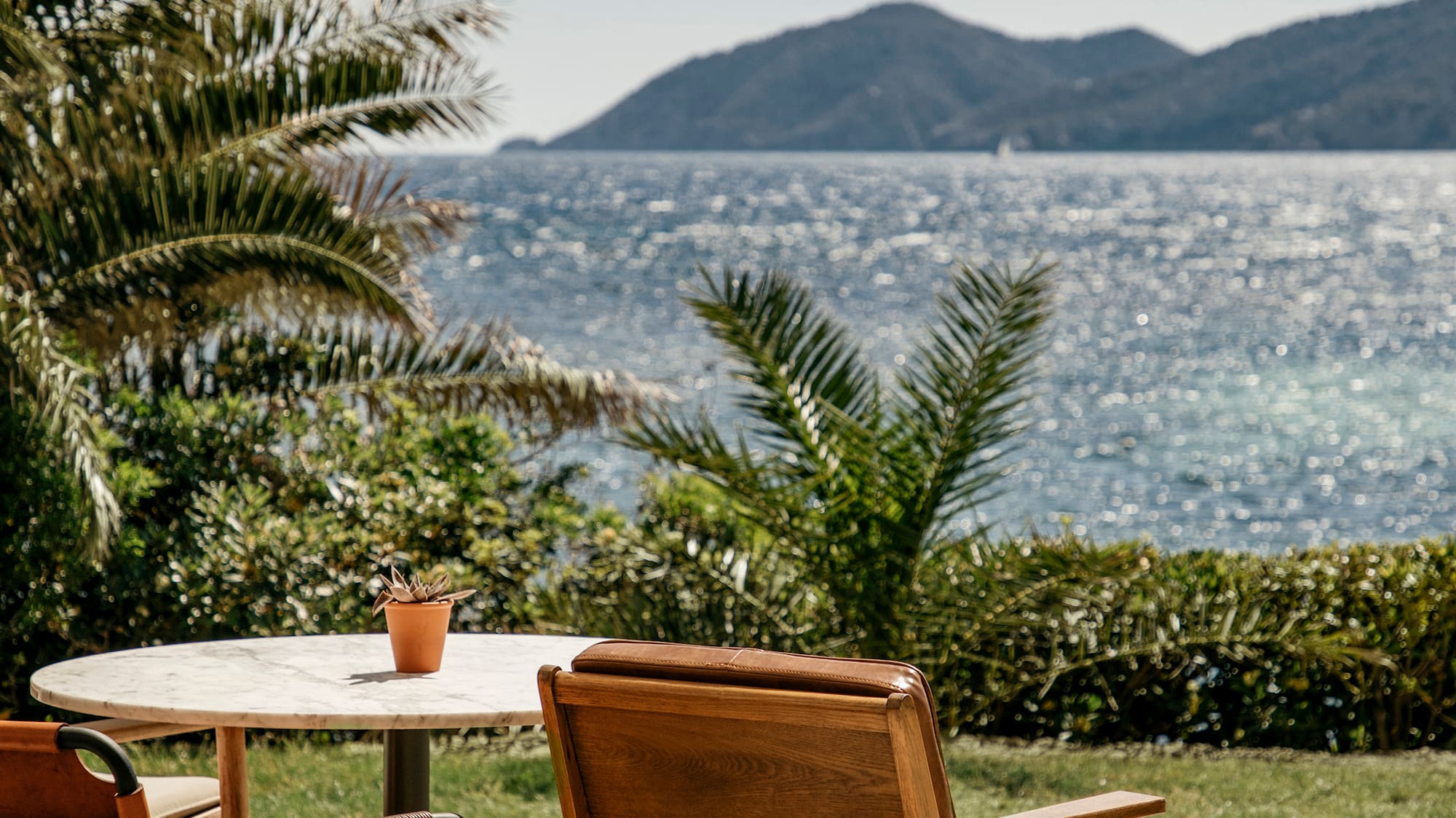 chairs and a table with a view of the ocean
