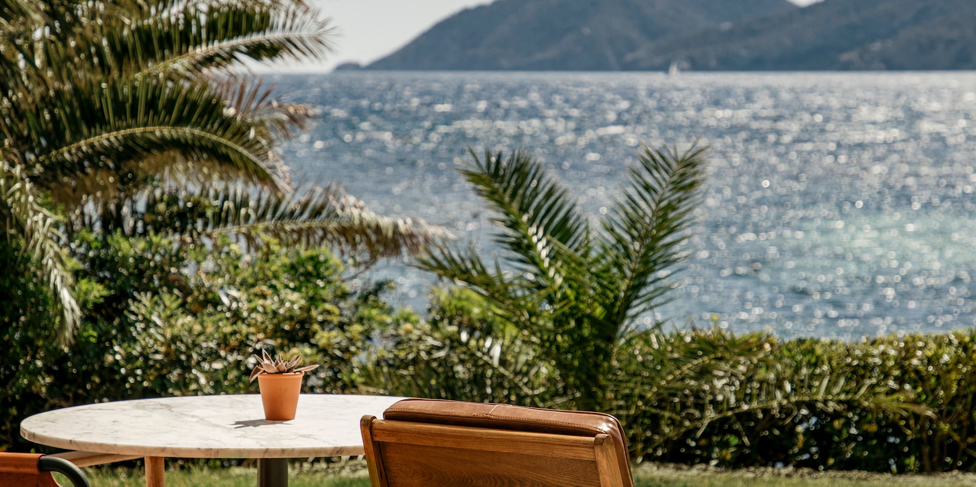 chairs and a table with a view of the ocean