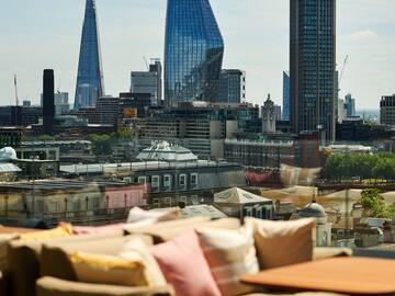 a couches and a table with a city skyline in the background