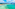 a beach with trees and mountains in the background
