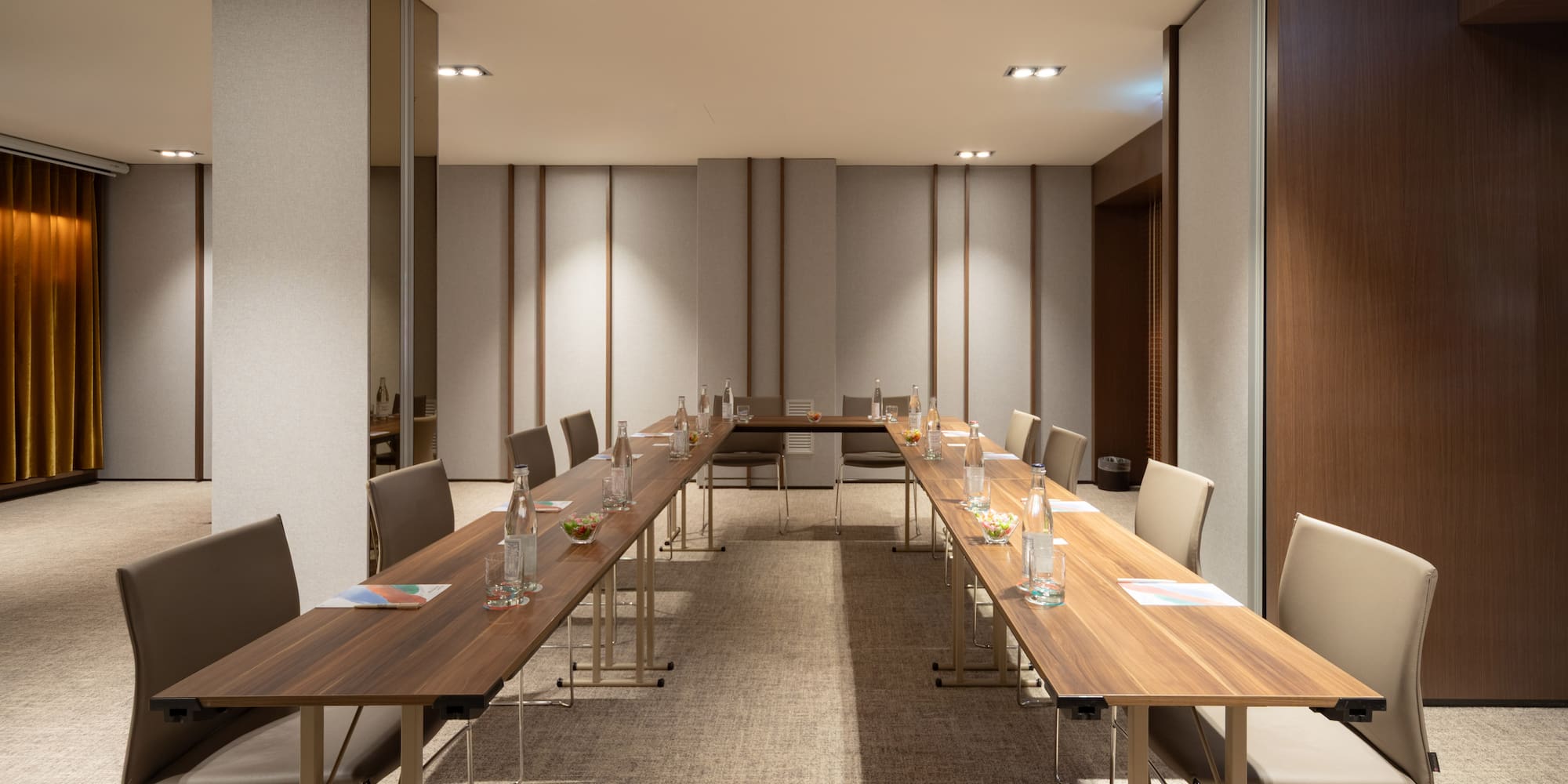 a room with long tables and chairs