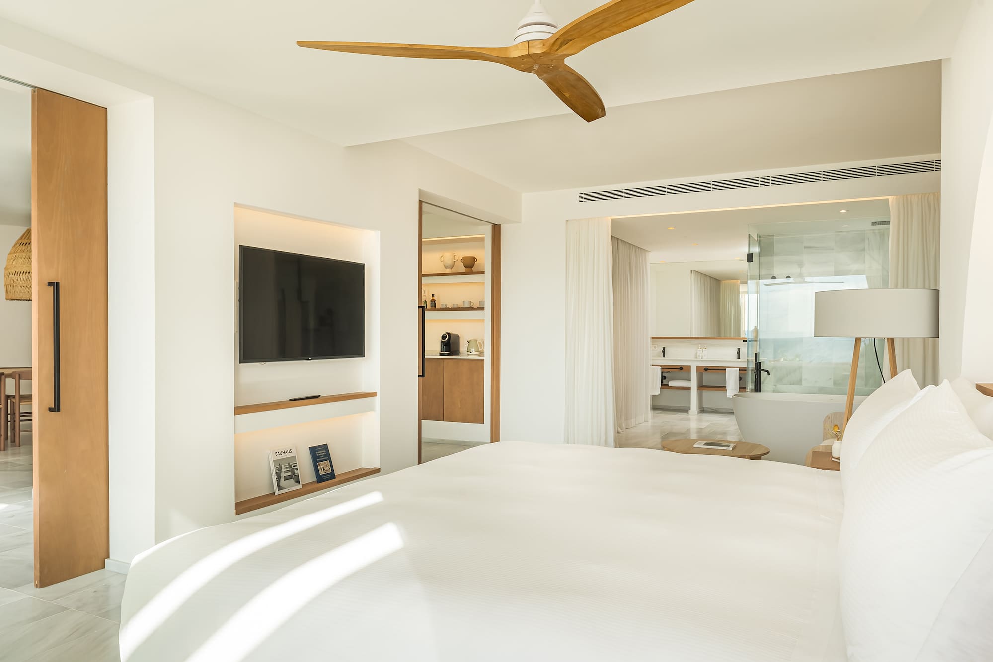 a room with a bed and a television