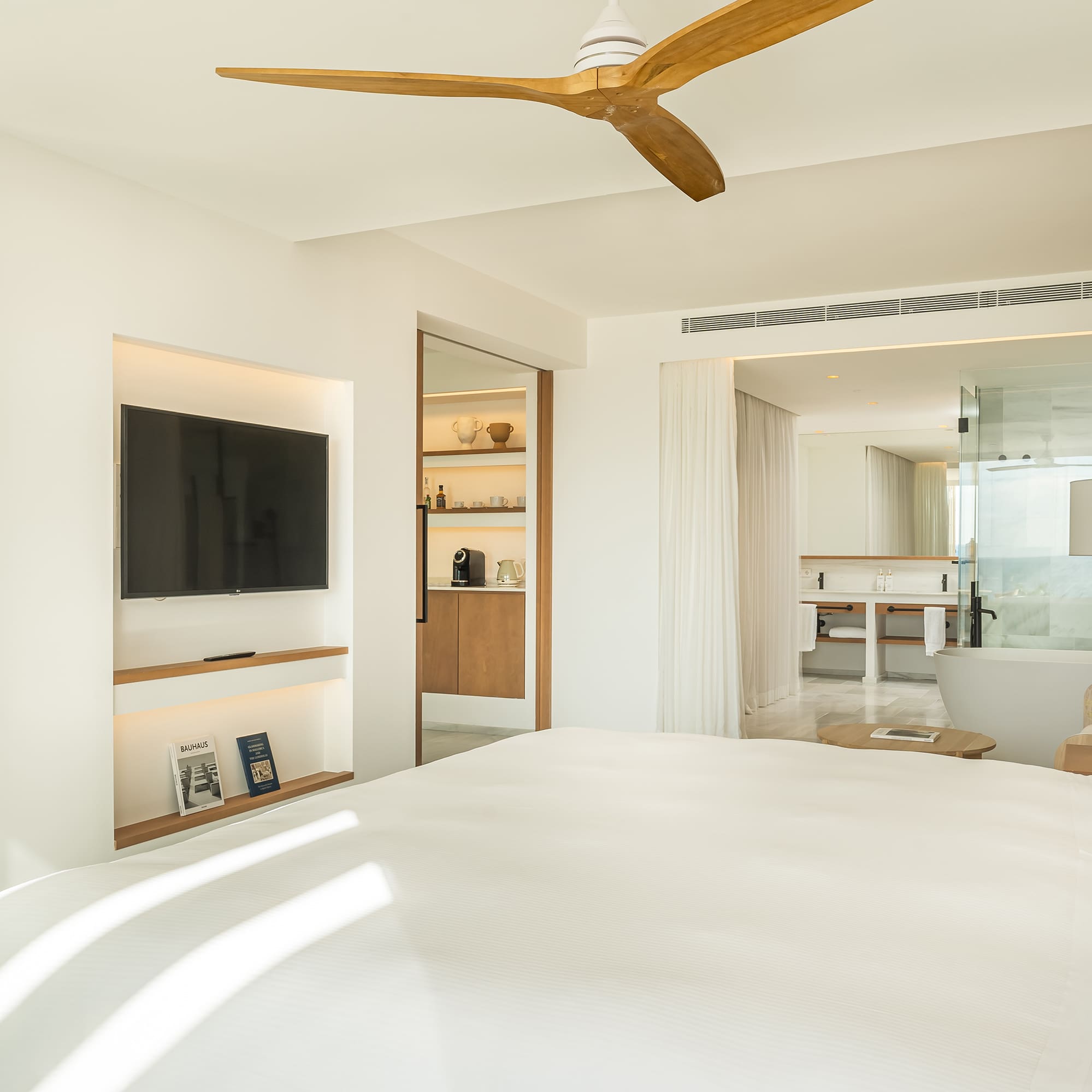 a room with a bed and a television