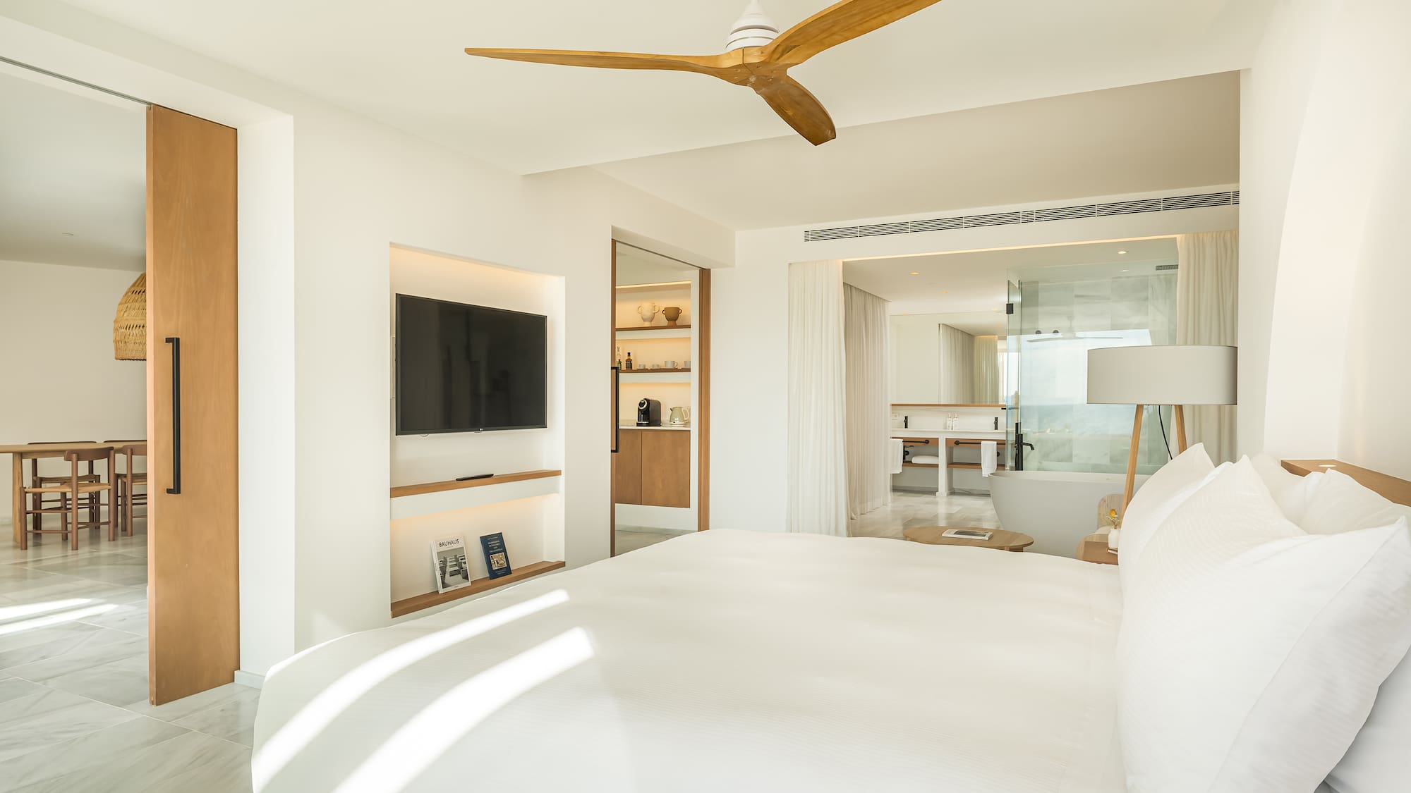 a room with a bed and a television