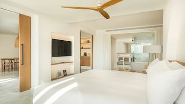 a room with a bed and a television