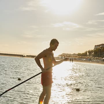 a man holding a rope in the water