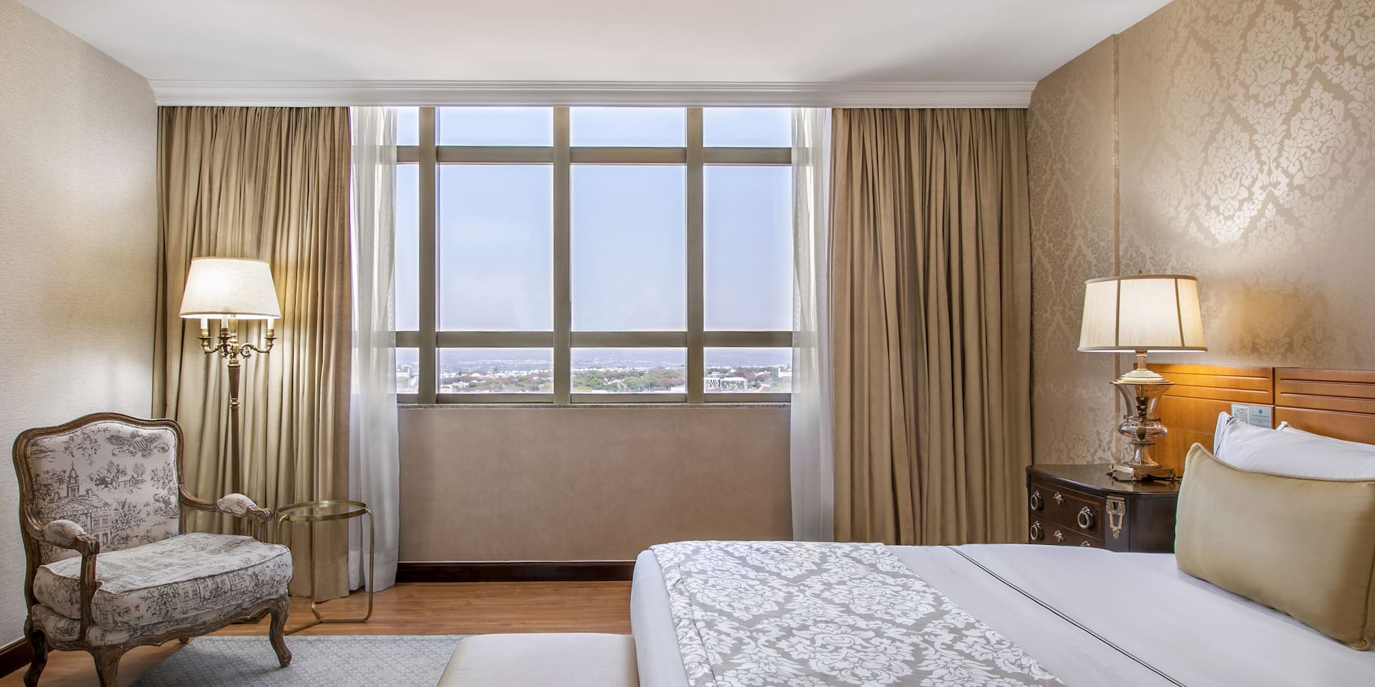 a bedroom with a bed and a chair