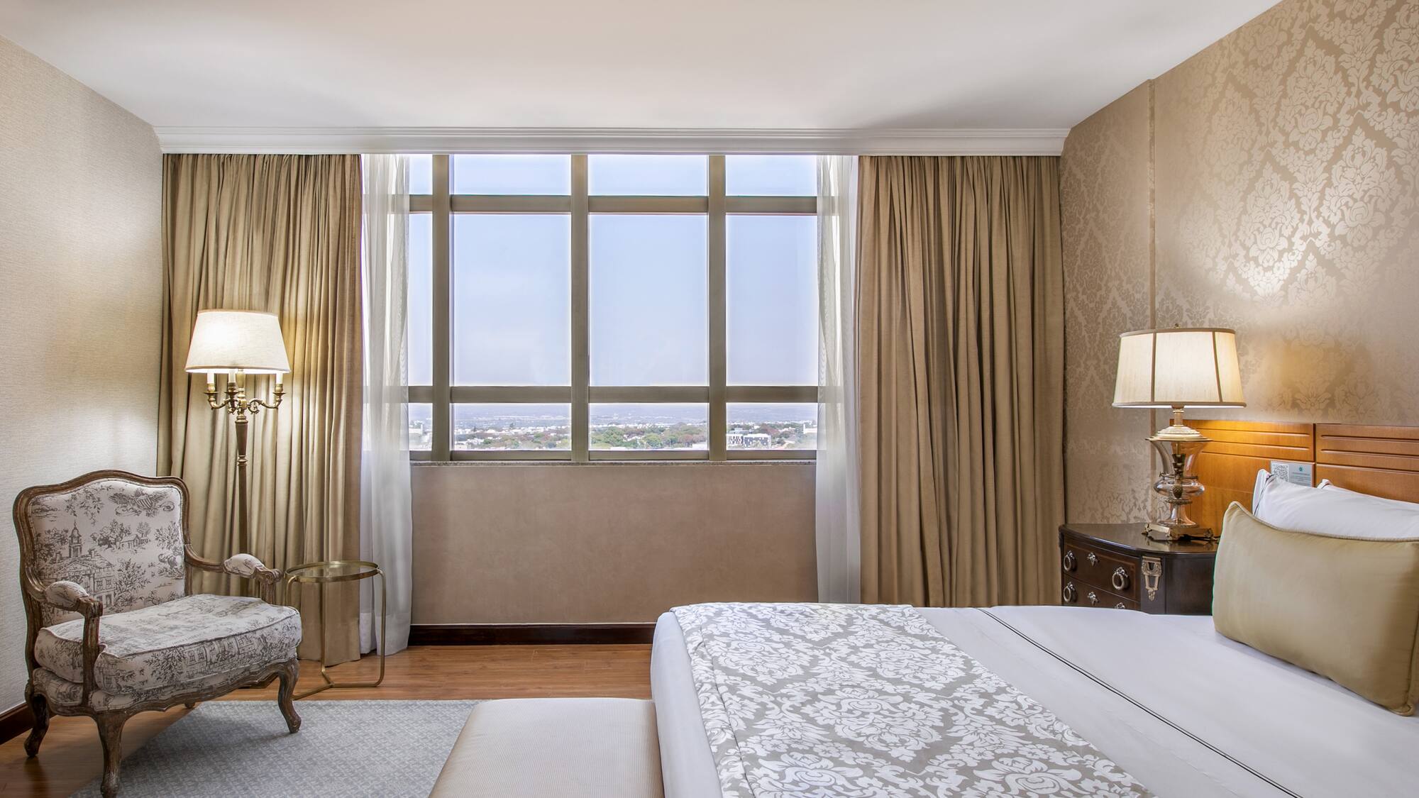 a bedroom with a bed and a chair