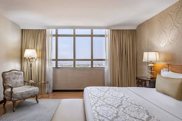 a bedroom with a bed and a chair