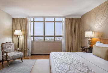 a bedroom with a bed and a chair