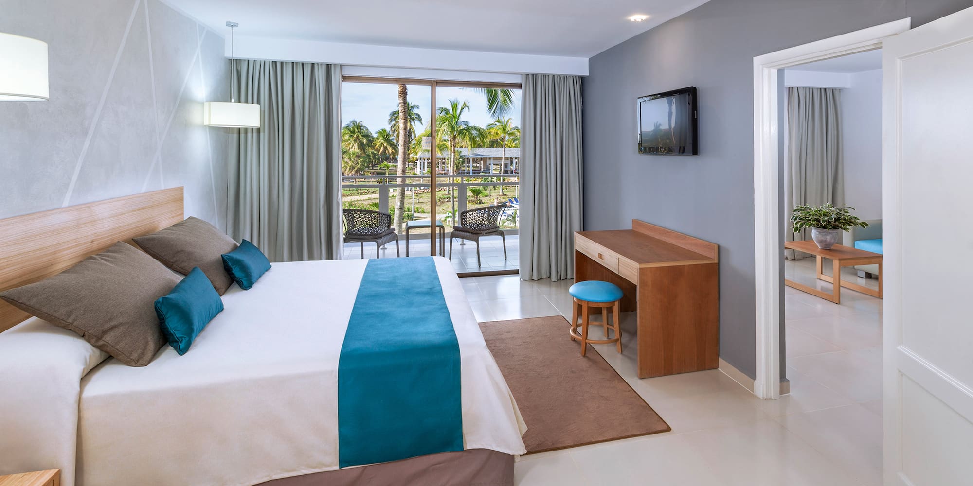 a bedroom with a bed and a television