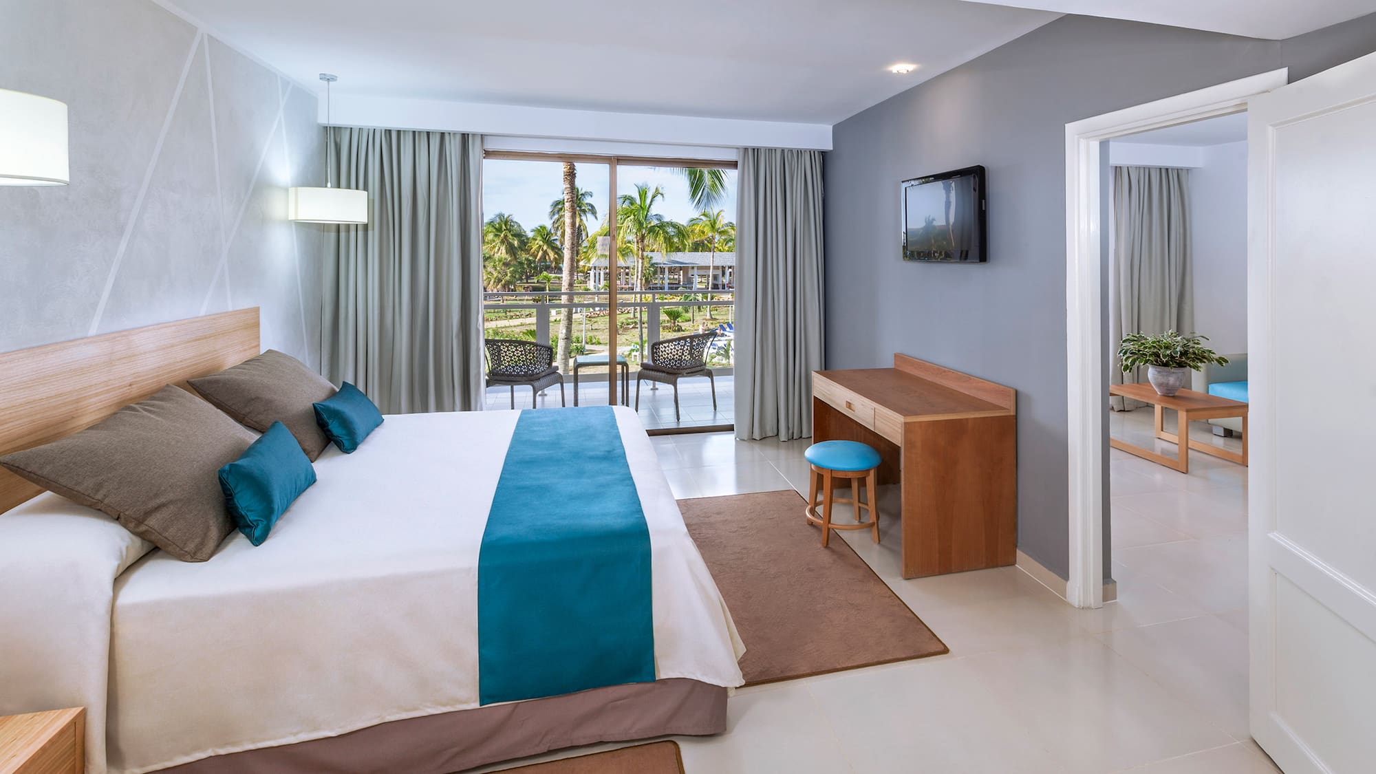 a bedroom with a bed and a television